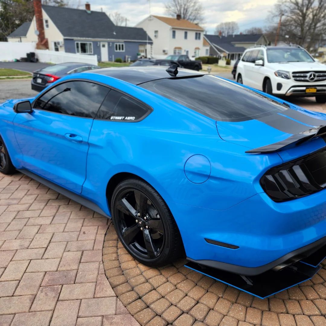 Blue Ford Mustang rear quarter after a detail