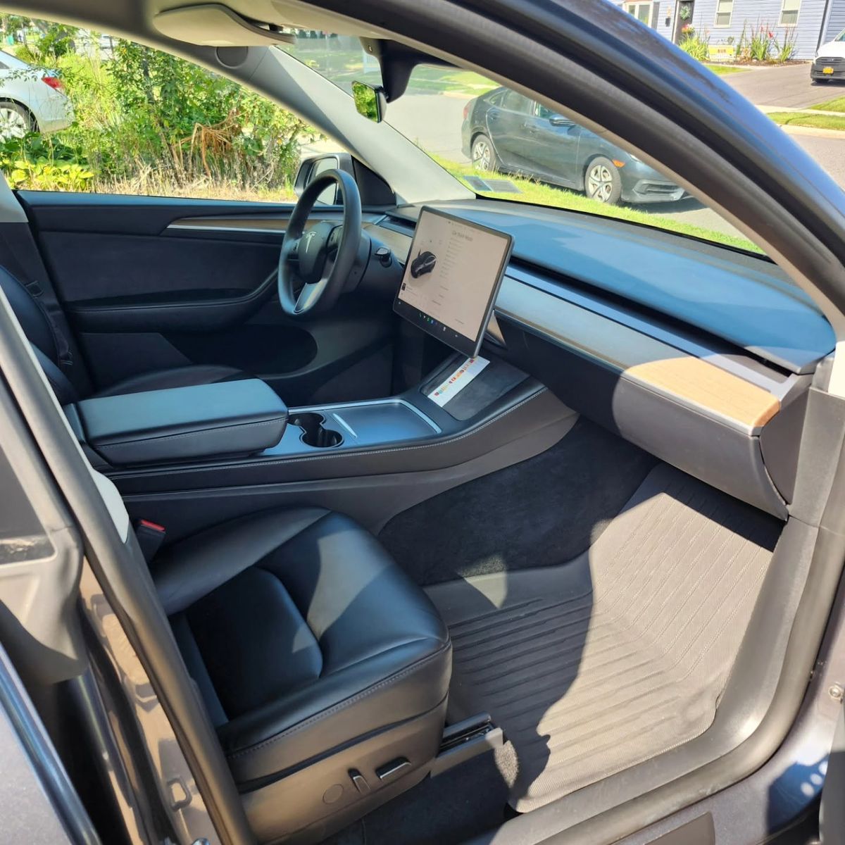 Clean Tesla Model Y front seats, dashboard and floor mats after an interior detail