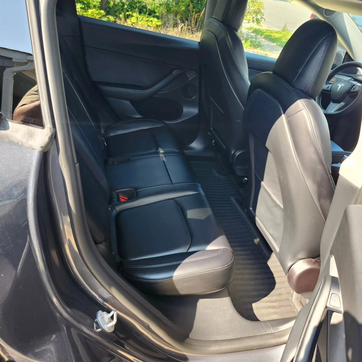 Clean black leather rear seat in a Tesla Model Y